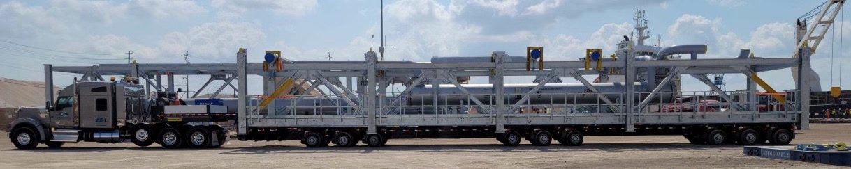 a truck carrying long equipment on the trailer