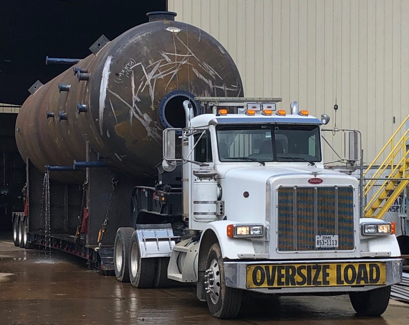 a trailer truck carrying a big tank