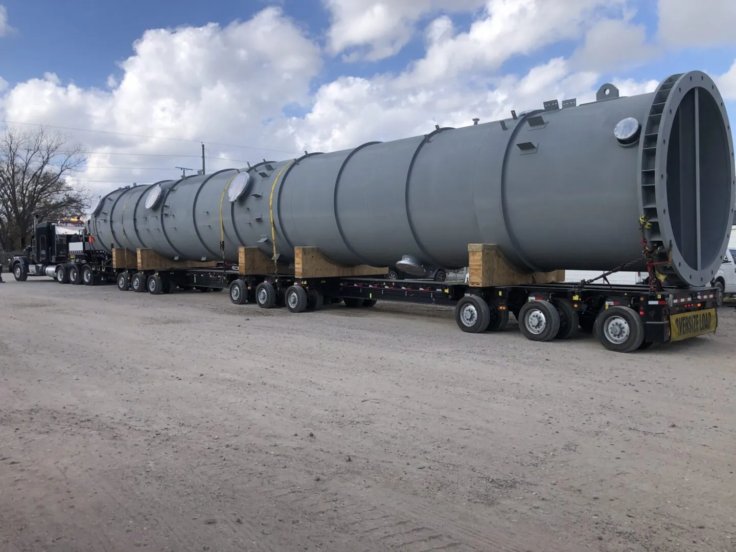 Large gray pressure vessel on a multi-axle trailer