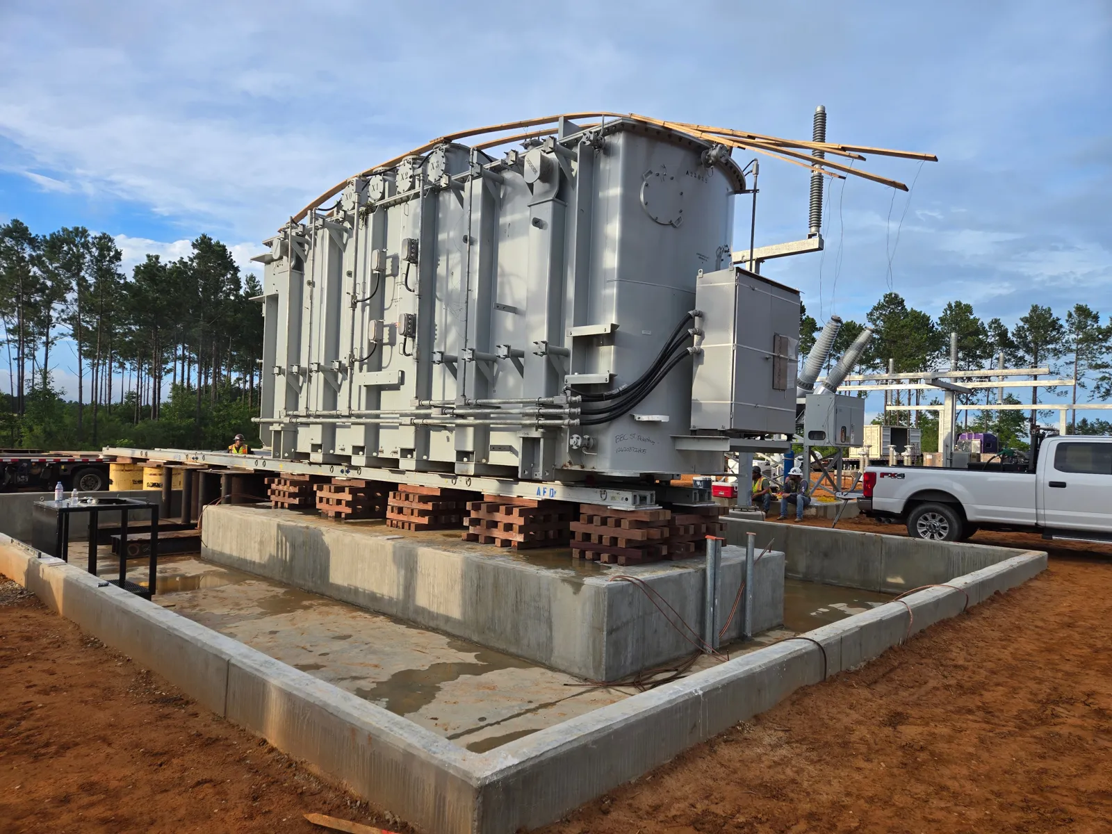 Transformer on cribbing and jacking stacks over a new foundation pad