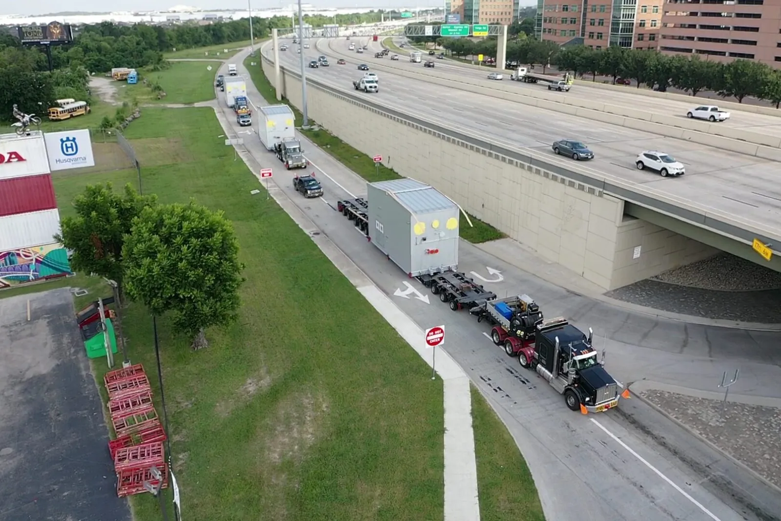 Convoy of semi-trucks hauling oversized modular units